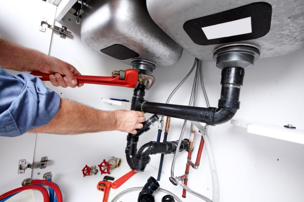 Athens Plumbing Pros fixing under sink plumbing and drain pipes