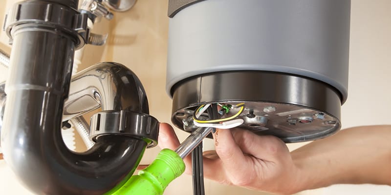 Athens, Georgia plumber servicing water heater pipe connection